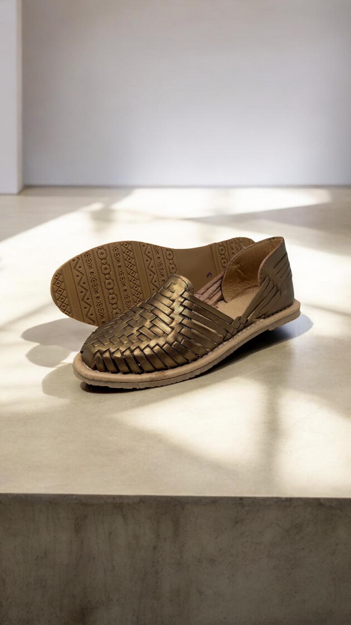 Artisan-made metallic leather huaraches with a closed-toe design