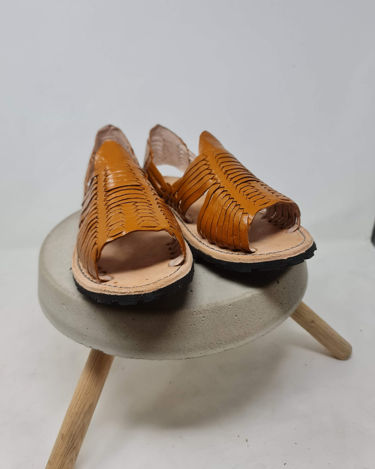Front view of men's open-toe huarache sandals showing the open toe and fine woven strips