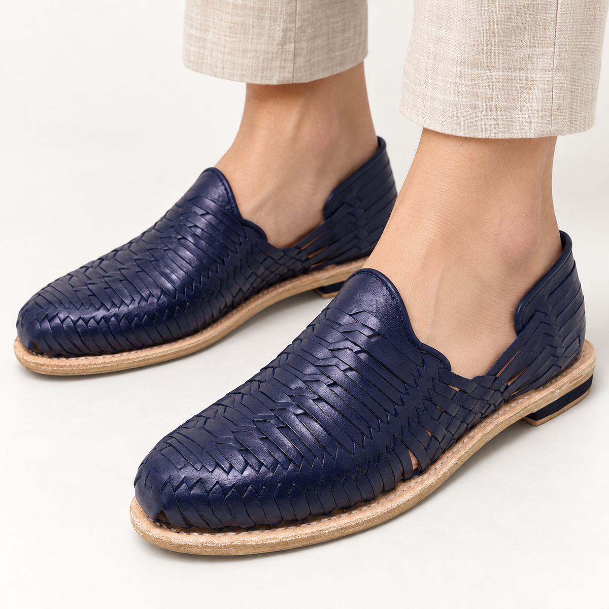 Close-up of the navy blue Escalera weave worn with light trousers; AI-generated styling image