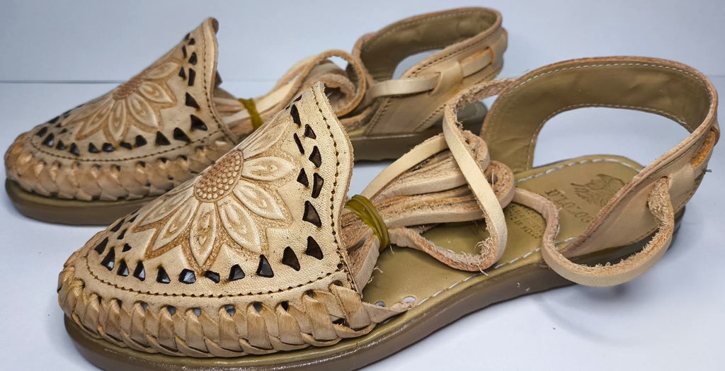 Side view of the honey Roman huaraches: woven sides, cutouts, long leather ties and flat synthetic sole