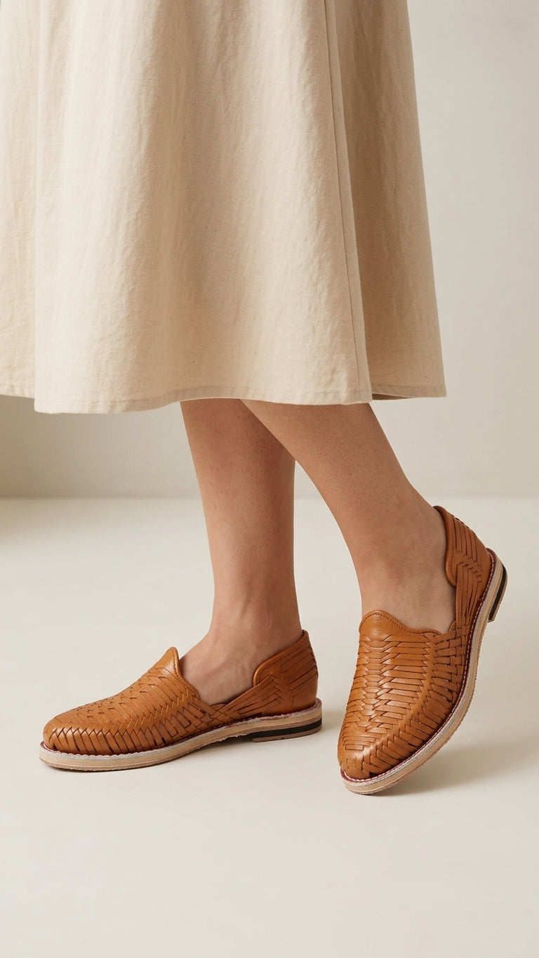 Women's Satchel Tan huarache sandals styled with a light linen skirt, AI-generated lifestyle image