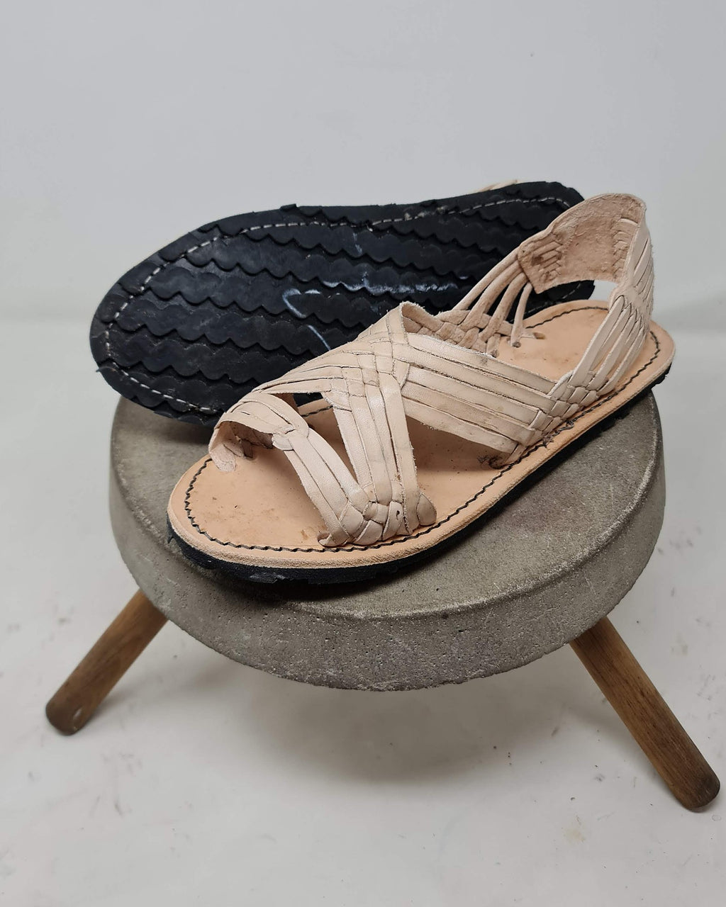 Men's open toe woven leather huarache sandals, natural leather, black rubber sole with wave tread and stitching, sole view